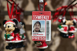 The old press pass of Gabriel San Román, former reporter for The OC Weekly, is displayed for a photograph in a gift store at Disneyland in Anaheim, Calif., on Dec. 10, 2019. (Federico Medina/The New York Times)