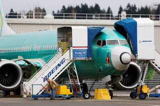 FILE PHOTO: An employee works near a Boeing 737 Max aircraft at Boeing's 737 Max production facility in Renton