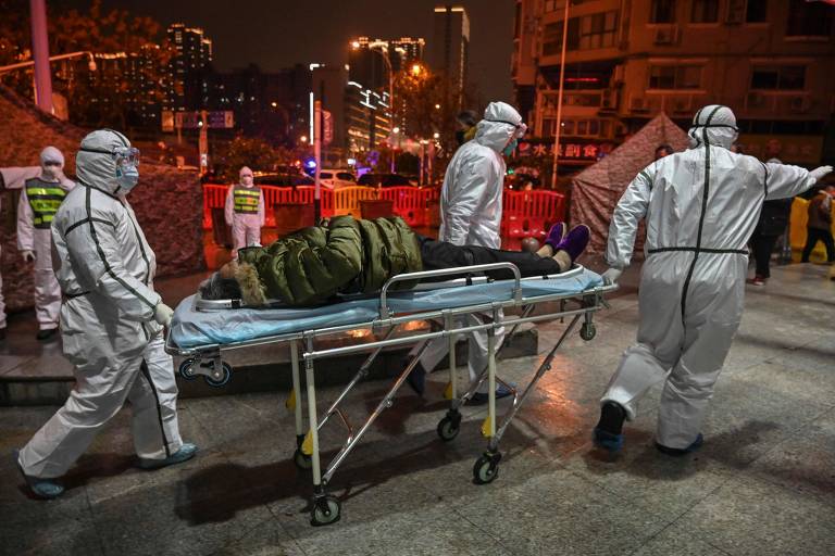 Equipe médica chega com paciente ao hospital da Cruz Vermelha em Wuhan, na China
