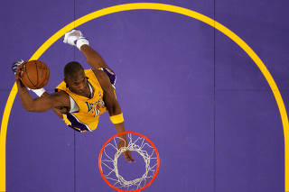 FILE PHOTO: Lakers Kobe Bryant goes up for a dunk against the New York Knicks during their NBA basketball game in Los Angeles