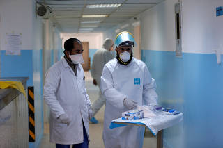 Members of the medical staff work at a new section specialised in receiving any person who may have been infected with coronavirus, at the Al-Bashir Governmental Hospital in Amman