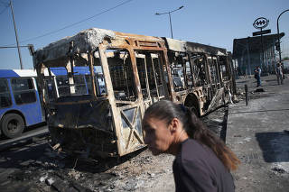 Burned bus is pictured after anti-government protests in Santiago
