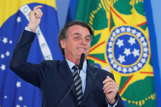Brazil's President Jair Bolsonaro speaks during a ceremony with country singers at the Planalto Palace in Brasilia