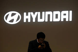 FILE PHOTO: A man walks past the logo of Hyundai Motor during the 2019 Seoul Motor Show in Goyang