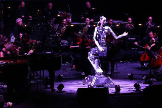 A robot maestro leads an orchestra at the Sharjah Performing Arts Academy in Sharjah