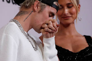 Singer Bieber kisses the hand of his wife Hailey Baldwin at the premiere for the documentary television series 