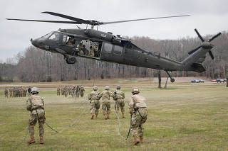 Soldiers attending The United States Army Air Assault School prepare to rappel from a UH-60 Blackhawk helicopter at Fort Campbell