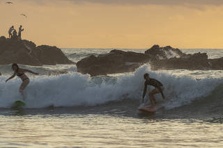 Surfing in La Punta, on Oaxaca's Pacific Coast in Mexico, Jan. 2020. (Adrian Wilson/The New York Times)
