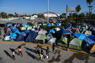 FILE PHOTO: Migrants, most of them asylum seekers sent back to Mexico from the U.S. under the 