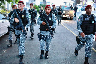 Members of National Force patrol a street during a military police strike in Fortaleza