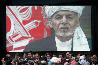 FILE PHOTO: A screen shows the broadcast of Afghanistan's President Ashraf Ghani speaks during his inauguration as president, in Kabul, Afghanistan