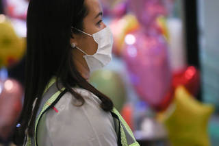 A labourer wearing a protective face mask works, after the third case of coronavirus in Sao Paulo was confirmed, at Guarulhos International Airport in Guarulhos