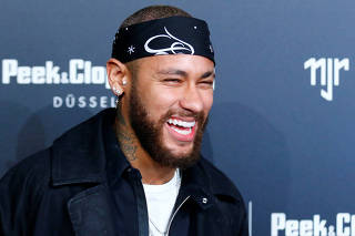 Brazilian football player Neymar of Paris St Germain poses as he arrives at an after show party following the launch event for the new Capsule Collection