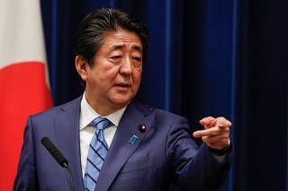 Japan's Prime Minister Shinzo Abe gestures as he speaks during a news conference on Japan's response to the coronavirus outbreak at his official residence in Tokyo