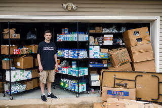 Matt Colvin with his stock of hand sanitizer and other supplies in demand due to coronavirus concerns that he was selling online until Amazon and other sites started cracking down on price gouging, at his home in Hixson, Tenn., March 12, 2020. (Doug Strickland/The New York Times)