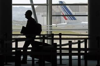 A passenger walks past check-in counters during Air France one-week strike at Marseille airport