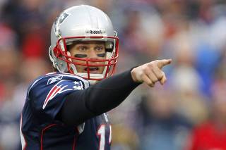 New England Patriots quarterback Tom Brady points on the line of scrimmage before a play against the Baltimore Ravens during their NFL AFC Championship football game in Foxborough
