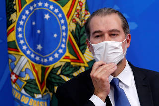 President of Brazil's Supreme Federal Court Dias Toffoli adjusts his protective face mask during a press statement to announce federal judiciary measures to curb the spread of the coronavirus disease (COVID-19) in Brasilia
