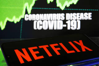 Netlix logo is seen in front of diplayed coronavirus disease (COVID-19)