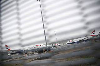 Parked British Airways planes are seen at Heathrow Airport in London