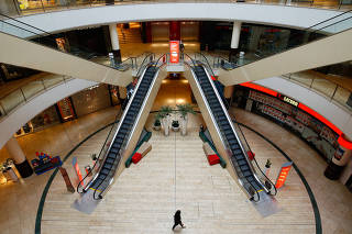 A person is seen inside an empty shopping mall during a partial lockdown in Leverkusen