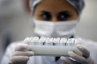 An employee of Brazilian health equipment startup Hi Technologies works in a batch of tests to diagnose the coronavirus disease (COVID-19), at their laboratory in Curitiba