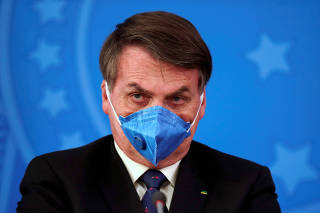 Brazil's President Jair Bolsonaro is pictured with his protective face mask at a press statement during the coronavirus disease (COVID-19) outbreak in Brasilia
