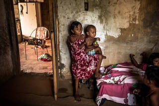 Silvany Vargas takesvcare of her little brother, Samuel in her home in Maracaibo, Venezuela on Jan. 18, 2020. (Meridith Kohut/The New York Times)