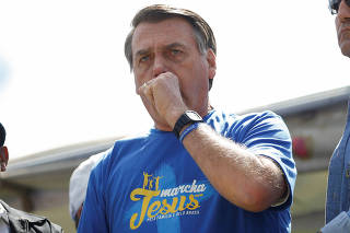 Brazil's President Jair Bolsonaro reacts during an evangelical march for Jesus in Brasilia