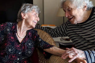 New Yorkers Eva Kollisch, left, and Naomi Replansky are staying in to reduce the risk of the coronavirus. (Mary-Elizabeth Gifford via The New York Times)