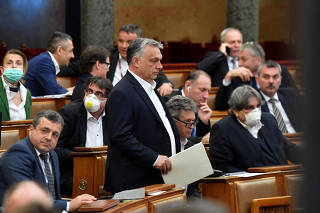 Hungarian Prime Minister Viktor Orban arrives to the plenary session of the Parliament ahead of a vote to grant the government special powers to combat the coronavirus crisis in Budapest