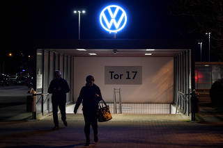 FILE PHOTO: Employees leave the Volkswagen plant after VW starts shutting down production in Europe amid the outbreak of coronavirus disease (COVID-19) in Wolfsburg