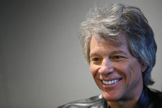 Jon Bon Jovi speaks to the media before a meeting with Britain's Prince Harry at Abbey Road Studios in London