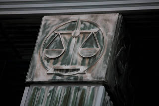 FILE PHOTO: An image of scales is pictured on a pillar of the Supreme Court in Warsaw