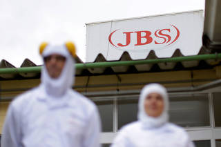 FILE PHOTO: Employees are seen at the Brazilian meatpacker JBS SA in the city of Lapa