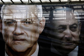 FILE PHOTO: A banner depicts Benny Gantz, leader of Blue and White party, and Israel Prime minister Benjamin Netanyahu, as part of Blue and White party's campaign ahead of the upcoming election, in Tel Aviv