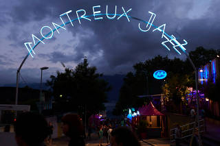 FILE PHOTO: Revellers walks near the Lake shore during the 48th Montreux Jazz Festival in Montreux