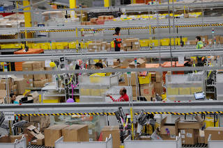 FILE PHOTO: Amazon workers perform their jobs inside of an Amazon fulfillment center on Cyber Monday in Robbinsville, New Jersey