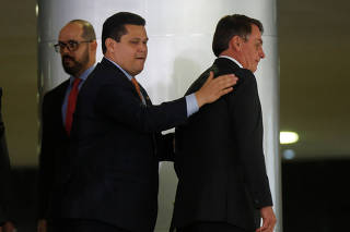 Brazil's Senate Davi Alcolumbre and Brazil's President Jair Bolsonaro are seen before an inauguration ceremony of the new Regional Development minister Rogerio Marinho (not pictured) at the Planalto Palace, in Brasilia