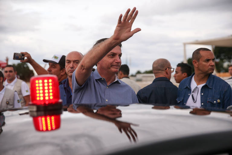 O presidente Jair Bolsonaro conversa e tira fotos com apoiadores na praça dos Três Poderes