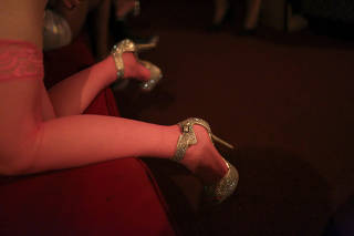A dancer gives her heels a break at an illicit New York strip club and brothel, informally known as Bliss Bistro.