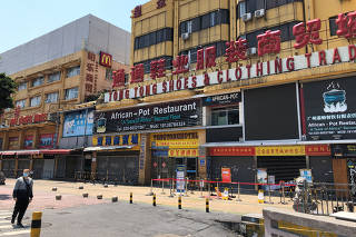 An African restaurant is closed off along with other businesses in Guangzhou's Sanyuanli area, where a neighborhood is in lockdown after several people tested positive for the novel coronavirus disease (COVID-19),  in Guangdong