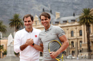 FILE PHOTO: Roger Federer and Rafael Nadal ahead of their 
