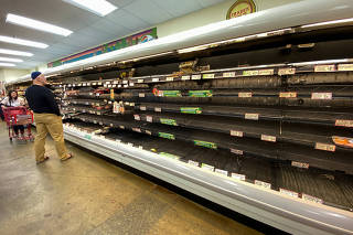 Shelves previously filled with meat and fish are seen empty at a Trader Joe's grocery store as shoppers gather supplies with coronavirus fears spreading in Encinitas, California