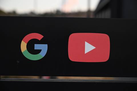 (FILES) In this file photo taken on November 21, 2019 the Google and YouTube logos are seen at the entrance to the Google offices in Los Angeles, California. - YouTube on April 28, 2020 began adding fact-check panels to search results in the US for videos on hot-topic claims shown to be bogus. (Photo by Robyn Beck / AFP)