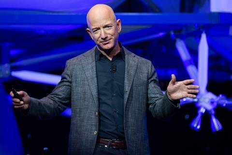 (FILES) In this file photo Amazon CEO Jeff Bezos announces Blue Moon, a lunar landing vehicle for the Moon, during a Blue Origin event in Washington, DC, May 9, 2019. - NASA on April 30, 2020 awarded almost $1 billion in contracts to three space companies including those owned by Elon Musk and Jeff Bezos to develop lunar landers as the United States seeks to return human beings to the Moon. The human landing system contracts were given to Musk's SpaceX, Bezos' Blue Origin and Dynetics, who receive $967 million. (Photo by SAUL LOEB / AFP) ORG XMIT: SAL023