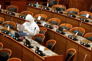 A Bolivian deputy wearing protective gear attends a Congress session, amid the spread of the coronavirus disease (COVID-19), in La Paz