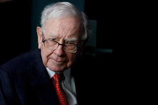 FILE PHOTO: Warren Buffett, CEO of Berkshire Hathaway Inc, pauses while playing bridge as part of the company annual meeting weekend in Omaha