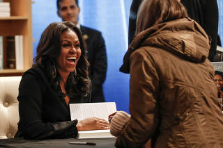 FILE PHOTO: Former first lady Michelle Obama signs copies of her memoir Becoming in Chicago