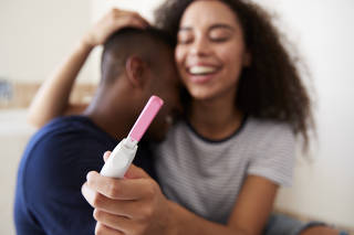 Couple Celebrating Positive Home Pregnancy Test Result